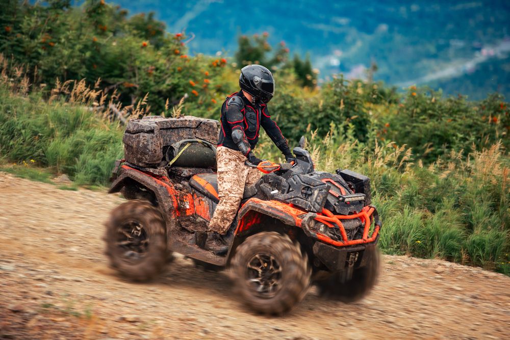 A quad bike in Sheregesh rides down a mountain slope in summertime